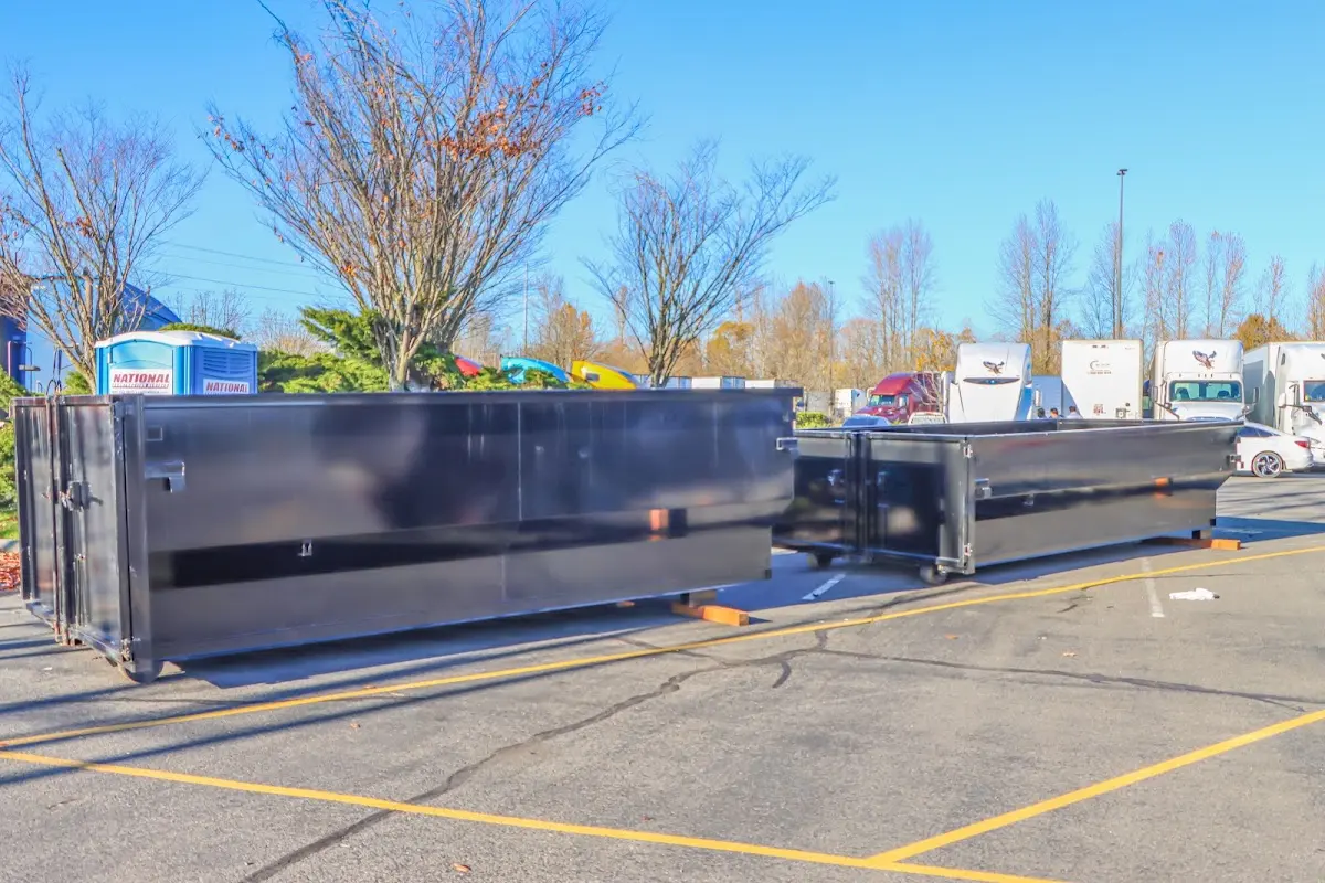 Professional dumpster rental service with roll-off container on residential driveway in Haltom City